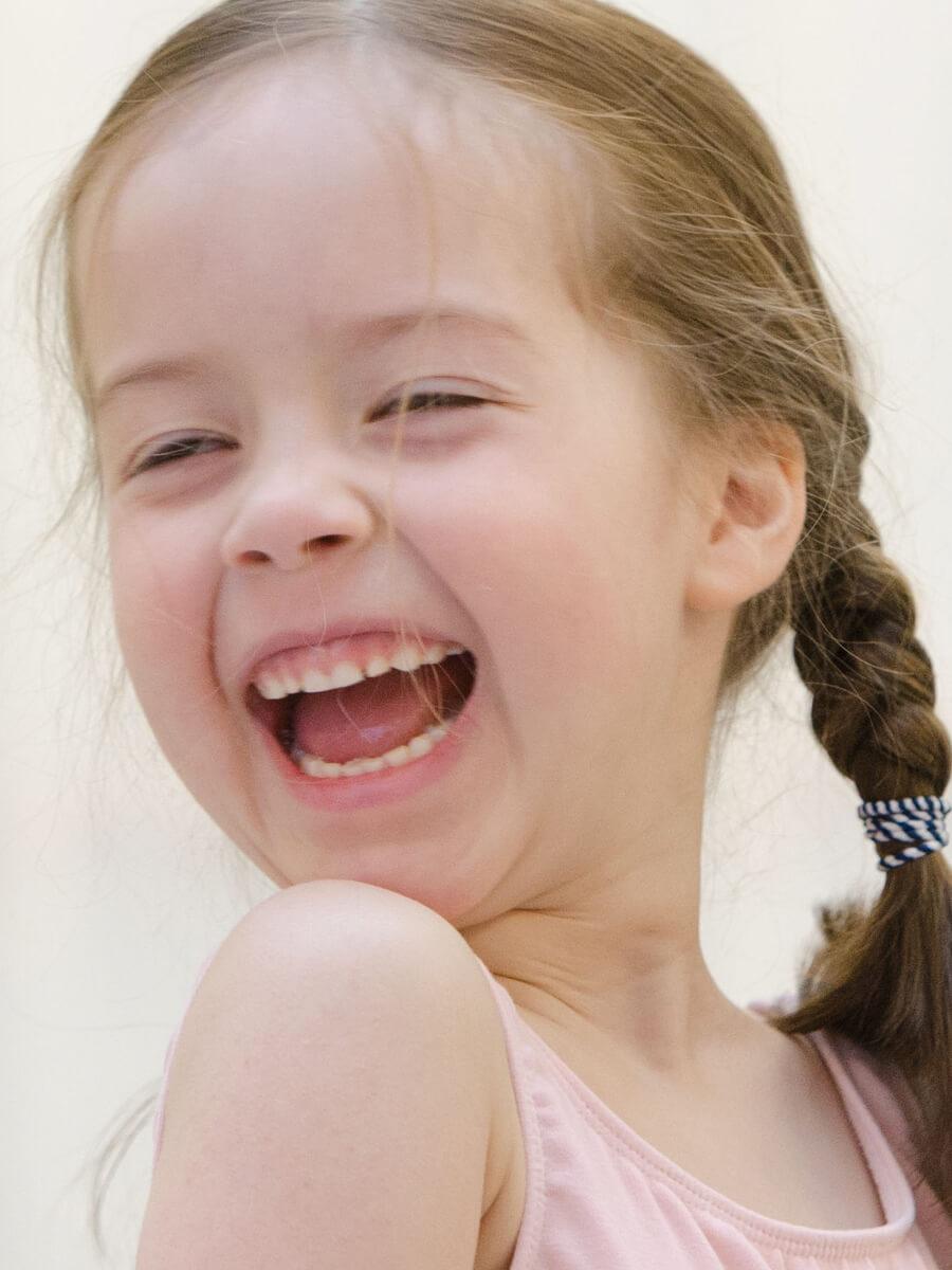 Young female ballet student laughing