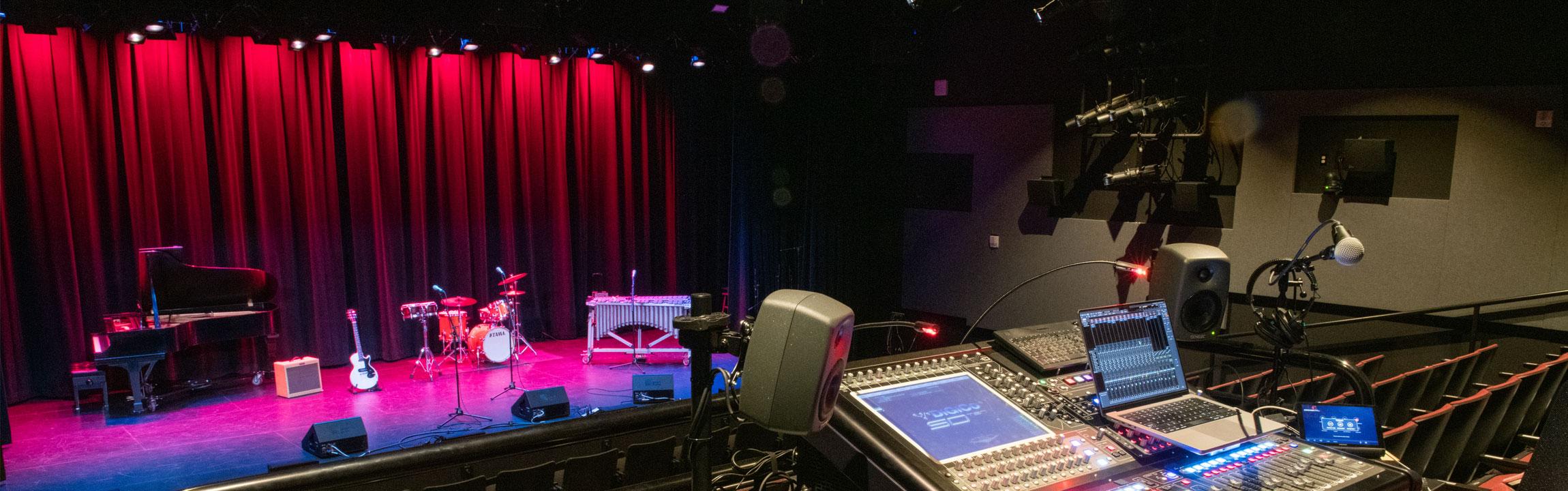 Raisbeck Hall inside with stage lit and control panel visible