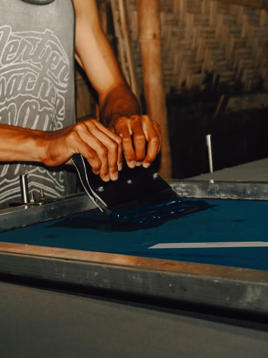 Person working with screen print substrate