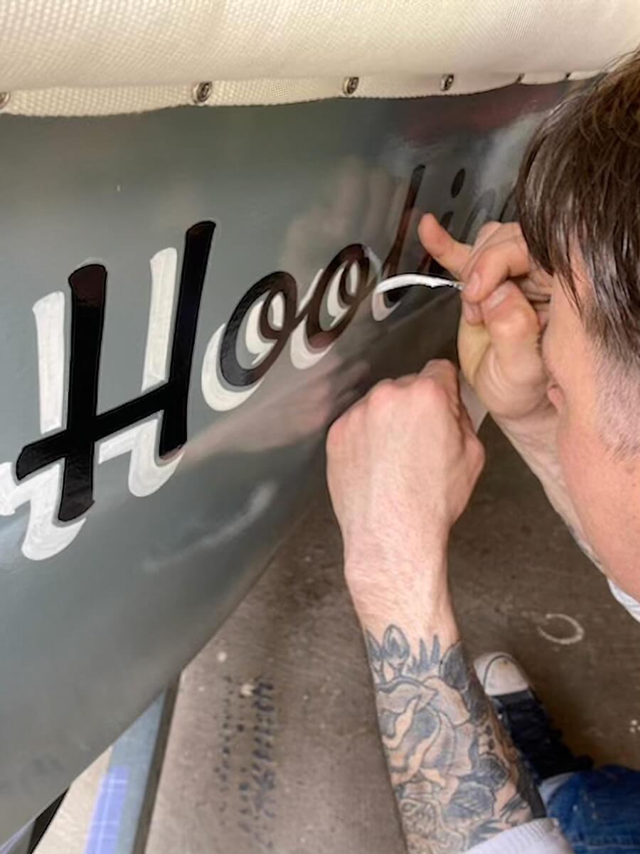 Person hand painting a sign
