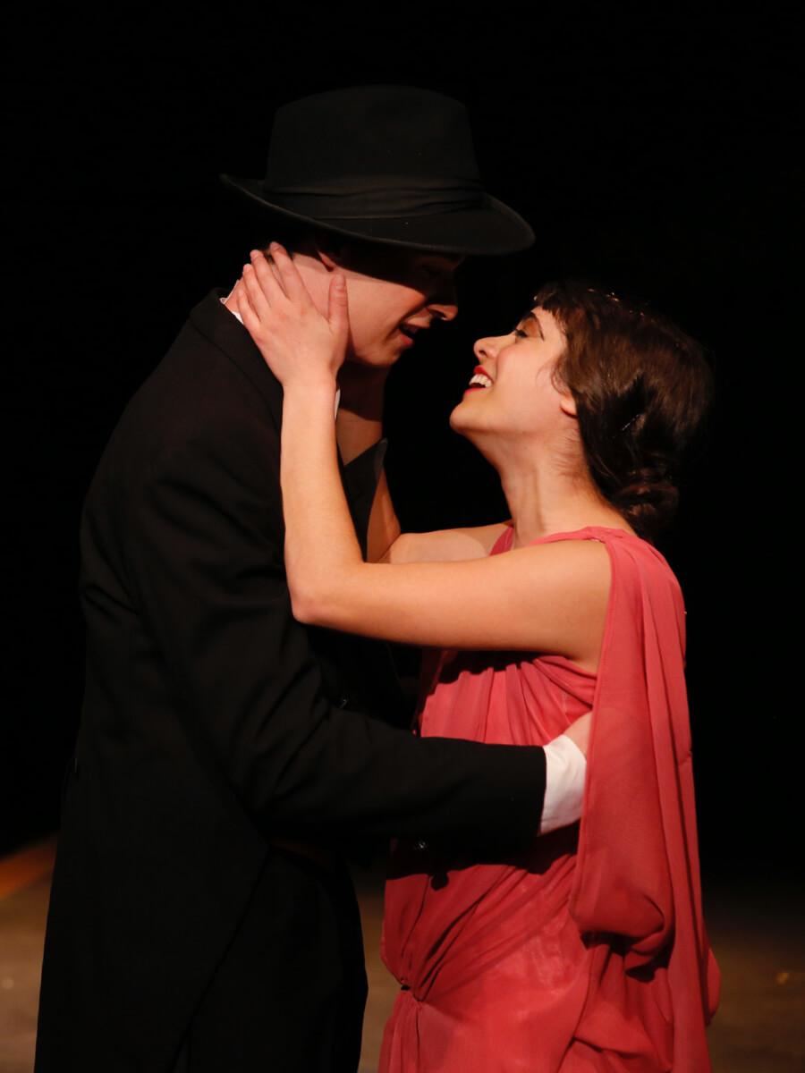 Man and woman on stage in an intimate embrace