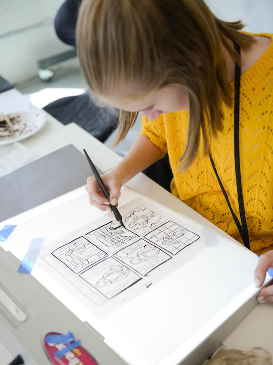 student working on comic drawings
