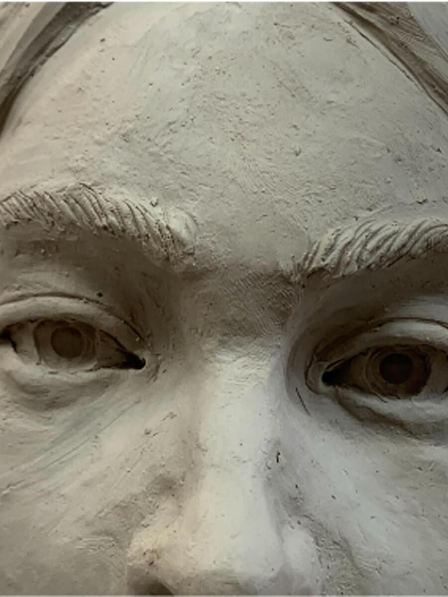 Clay sculpture of a Native American close up face