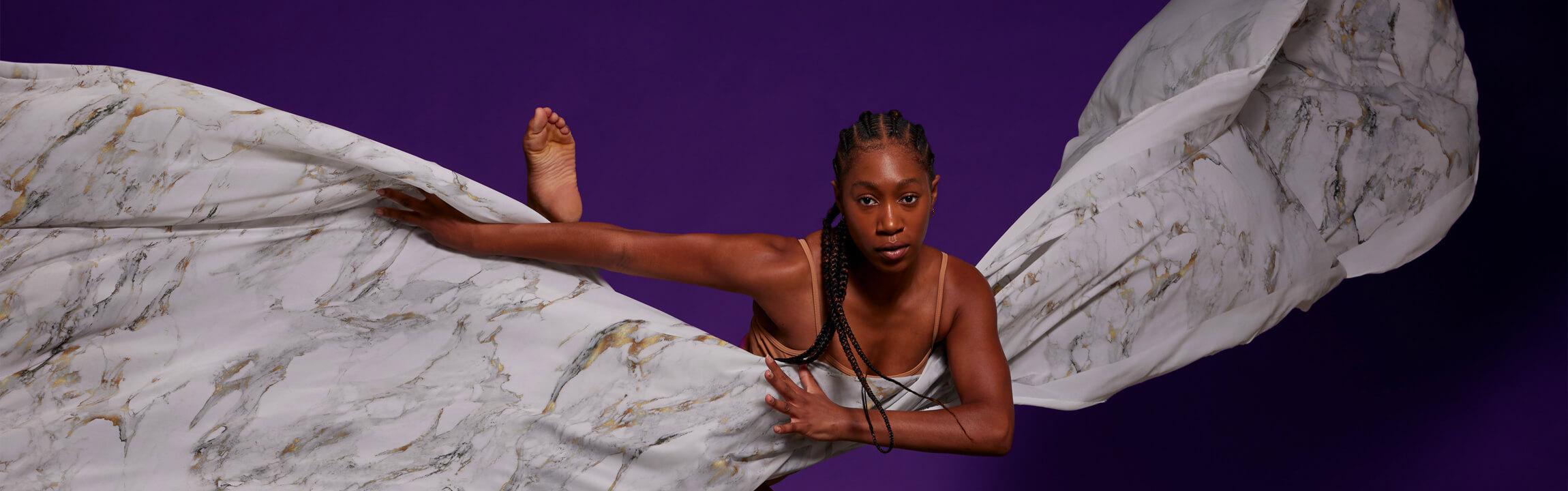 black woman dancing with large white billowy sheet