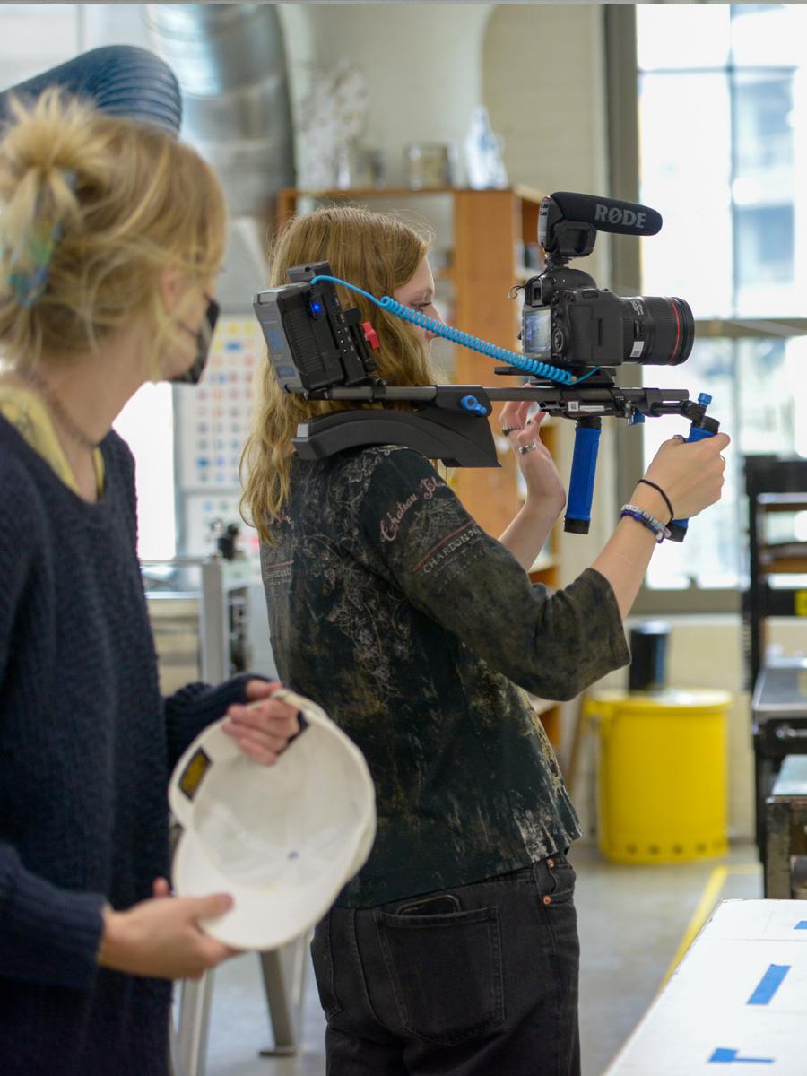 students filming in a studio large windows for documentary study