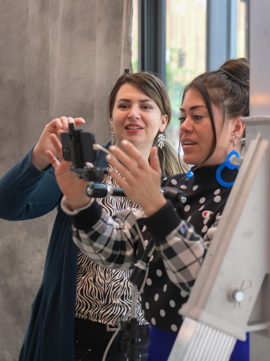 two women looking at digital camera