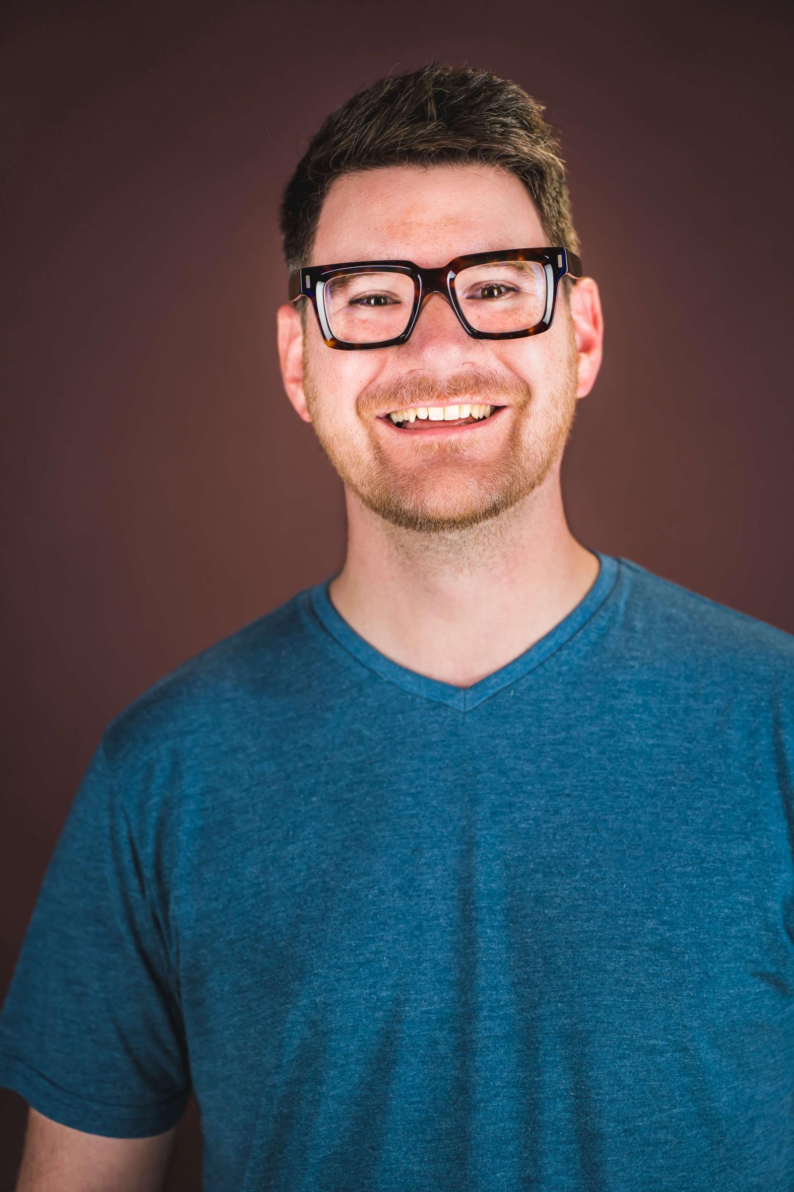 David Taylor Gomes in a blue tshirt with glasses