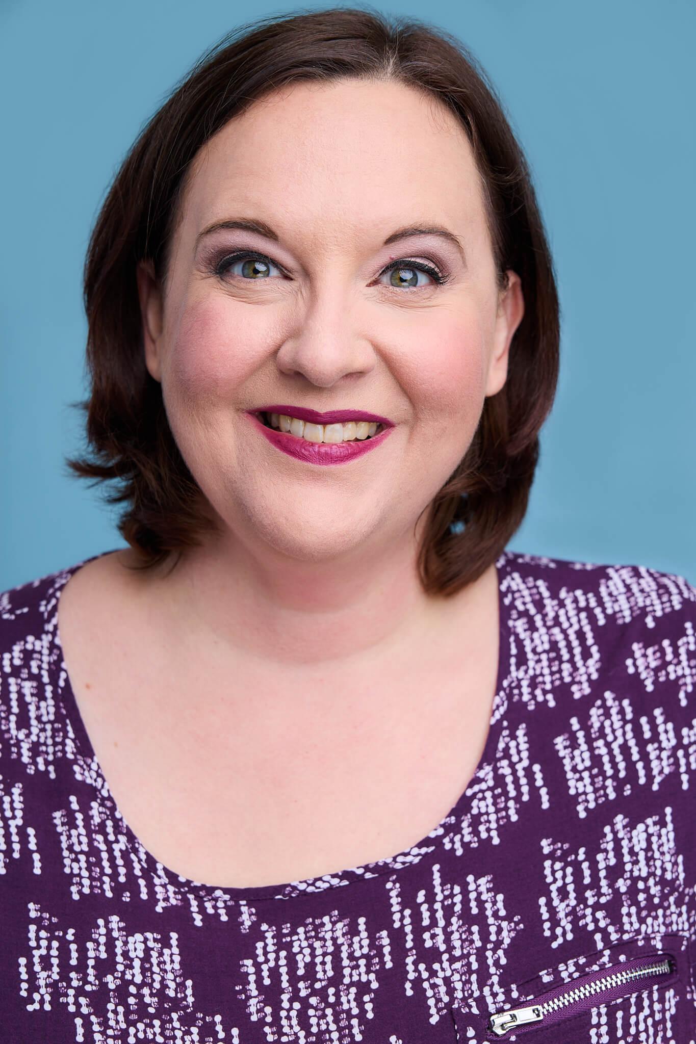 Kate Jaeger with short brown hair and a purple shirt. 