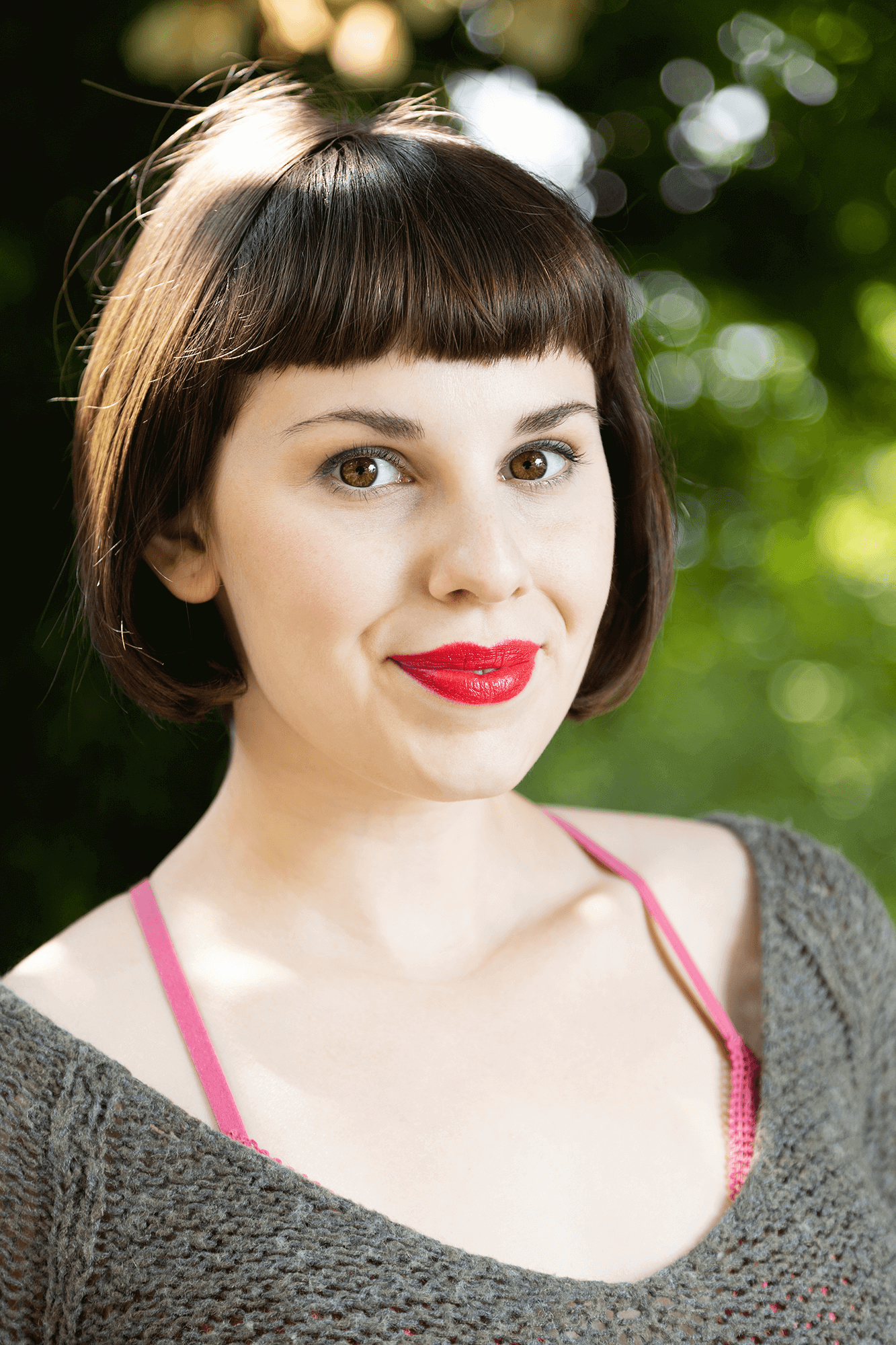 Sophia Franzella in a grey shirt with short brown hair. 