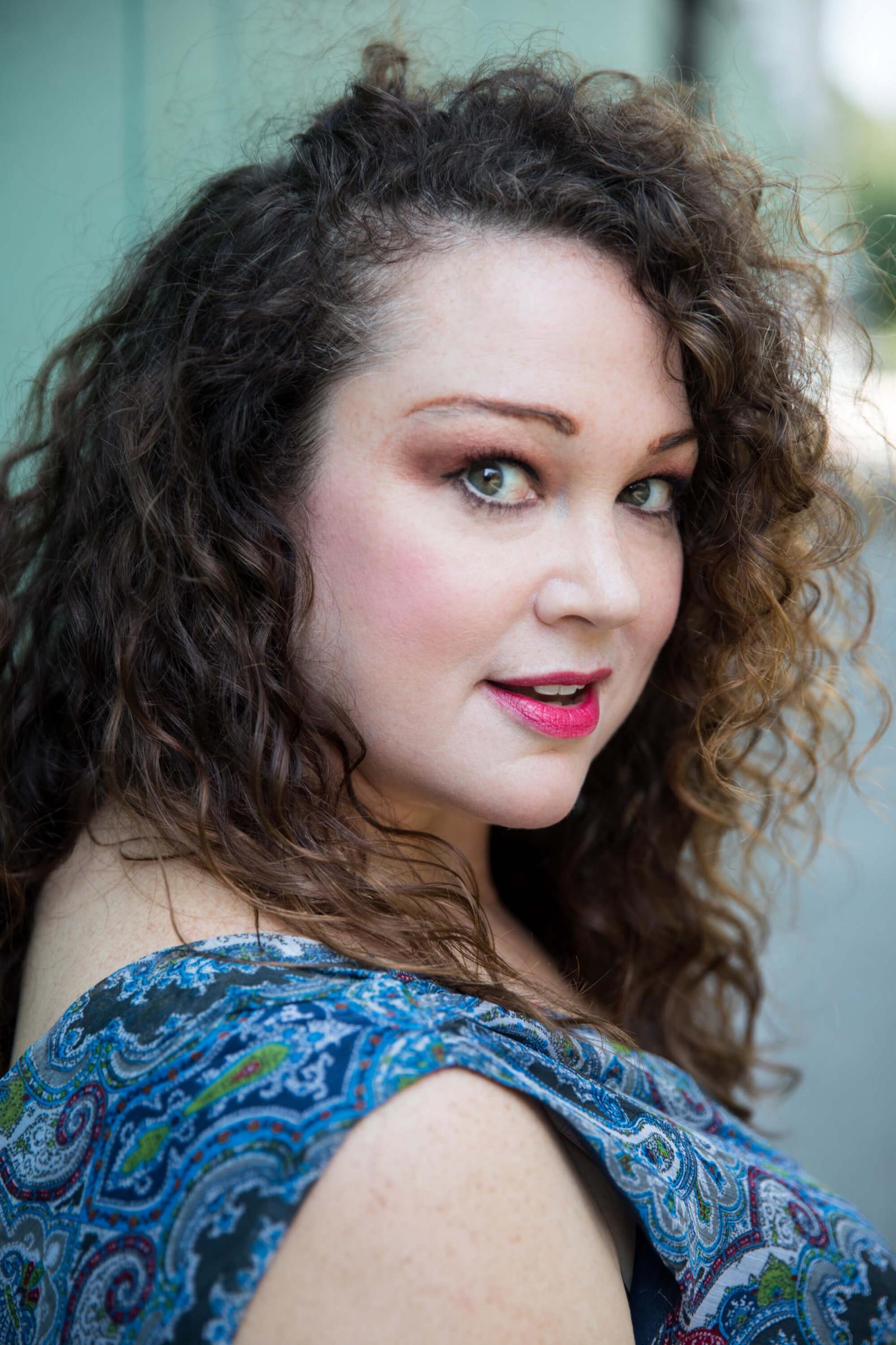 Heidi Vanderford in a blue dress long curly brown hair. 