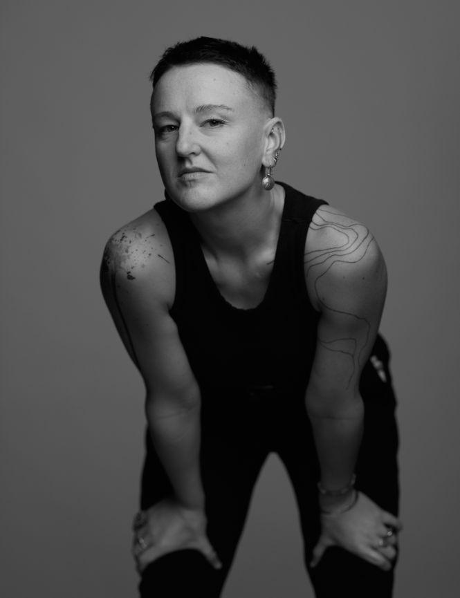 Alethea Alexander dance teacher black and white photo with a tank top and short hair