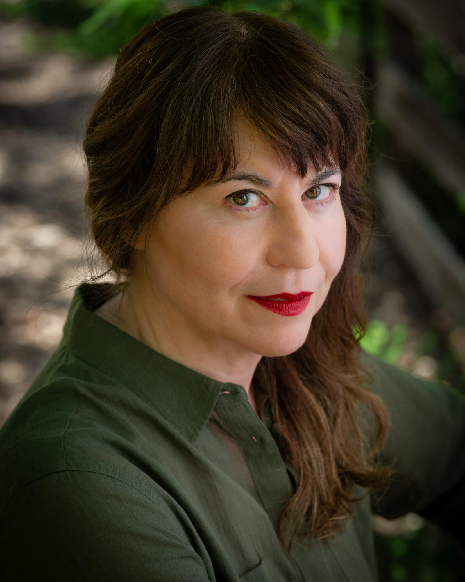 Tonya Lockyer in a green shirt with brown hair headshot