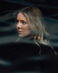 Hilary Grumman in a foggy black and blond headshot