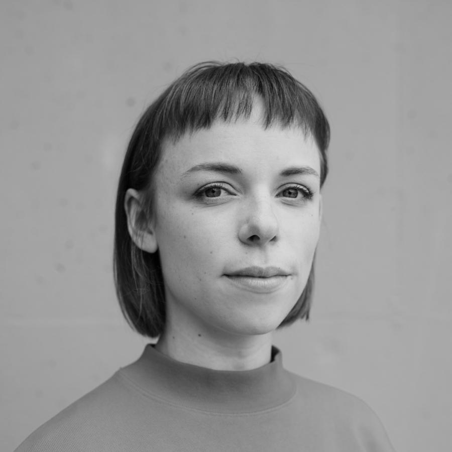 Lexi Dysart headshot in a black and white photo with short brown hair. 